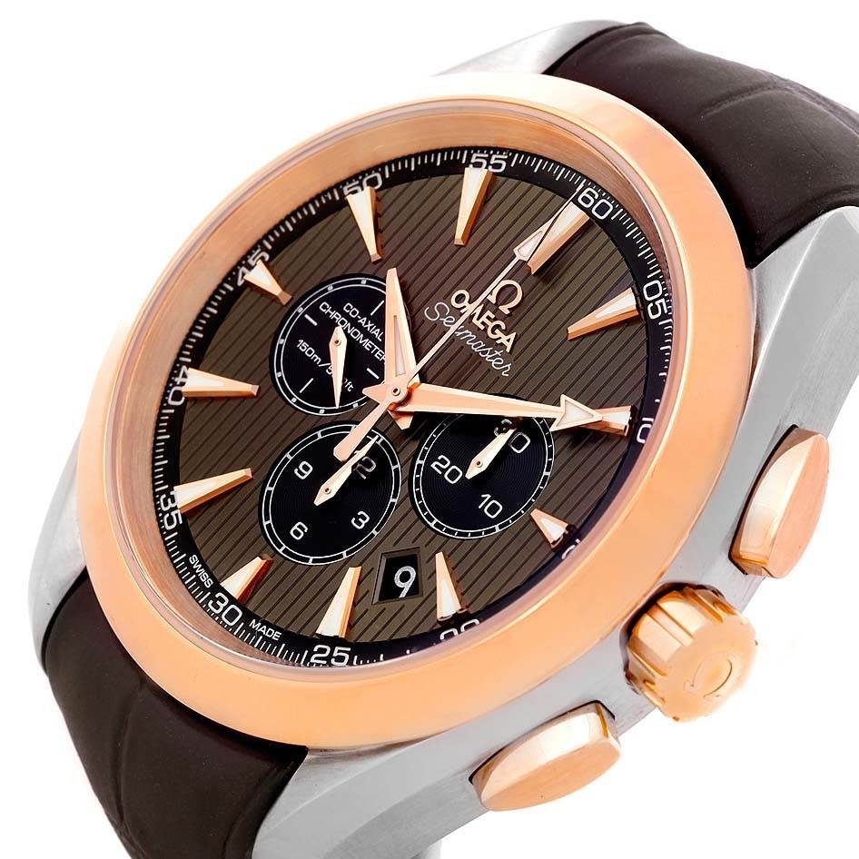 The image shows an angled view of an Omega Aqua Terra 231.23.44.50.06.001 Men's Steel and Gold (two tone) Grey Dial 231.23.44.50.06.001 Men's Steel and Gold (two tone) Grey Dial model watch, highlighting its bezel, chronograph subdials, crown, and pushers.