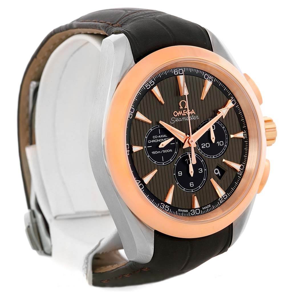 The image shows an Omega Aqua Terra 231.23.44.50.06.001 Men's Steel and Gold (two tone) Grey Dial 231.23.44.50.06.001 Men's Steel and Gold (two tone) Grey Dial watch from a side angle, highlighting its black leather strap, gold-tone bezel, and dial details.