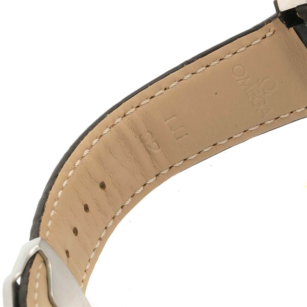 The image shows the underside of the leather strap of the Omega Aqua Terra 231.23.44.50.06.001 Men's Steel and Gold (two tone) Grey Dial 231.23.44.50.06.001 Men's Steel and Gold (two tone) Grey Dial watch, featuring the brand's logo and stitching details.