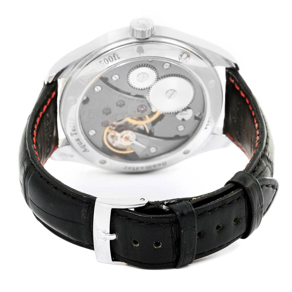 The image shows the back view of the Omega Aqua Terra 231.13.49.10.06.001 Men
s Stainless Steel Grey Dial 231.13.49.10.06.001 Men
s Stainless Steel Grey Dial watch, highlighting its transparent case back and internal mechanisms along with a black leather strap with red stitching.