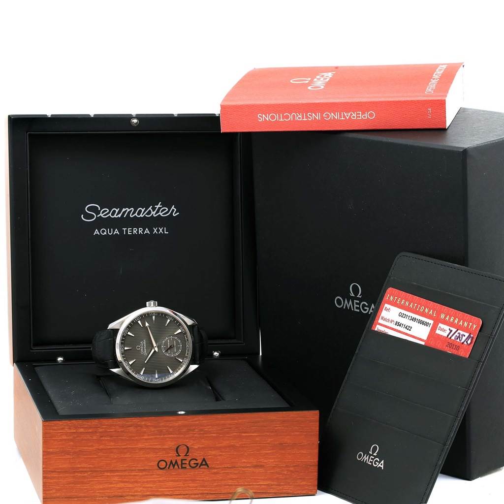 The image shows an Omega Aqua Terra 231.13.49.10.06.001 Men
s Stainless Steel Grey Dial 231.13.49.10.06.001 Men
s Stainless Steel Grey Dial watch in its box, along with the instruction manual and warranty card.