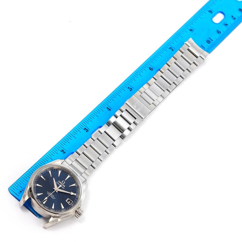 The image shows a top-down view of the Omega Aqua Terra 231.10.39.21.03.001 Men
s Stainless Steel Blue Dial 231.10.39.21.03.001 Men
s Stainless Steel Blue Dial watch, including its face, bracelet, and part of a measurement scale in inches.