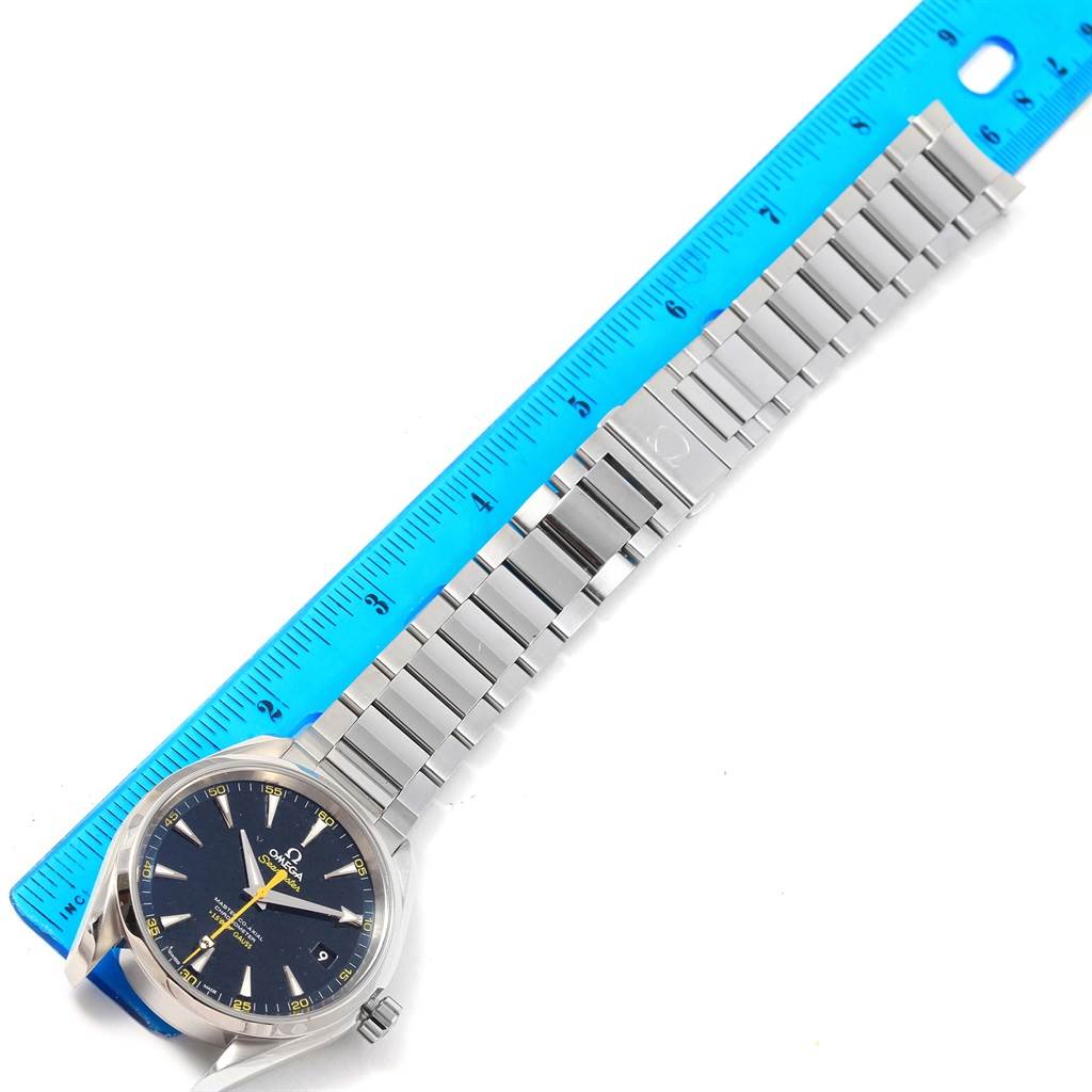 The image shows an Omega Aqua Terra 231.10.42.21.03.004 Men's Stainless Steel Blue Dial 231.10.42.21.03.004 Men's Stainless Steel Blue Dial watch with a stainless steel bracelet, lying next to a blue ruler.