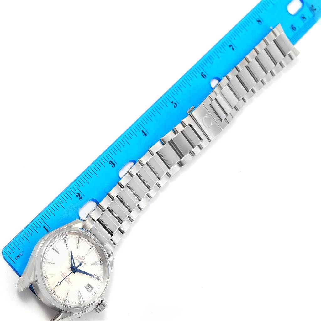 The image shows an Omega Aqua Terra 231.10.42.21.02.002 Men
s Stainless Steel Silver Dial 231.10.42.21.02.002 Men
s Stainless Steel Silver Dial watch at an angle revealing its face, bracelet, and clasp, aligned next to a blue ruler.