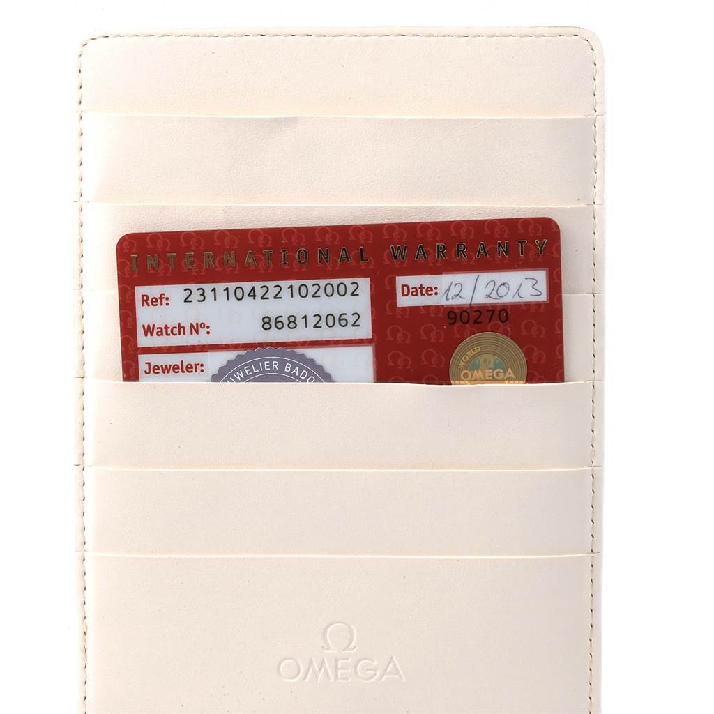 This image shows the international warranty card for the Omega Aqua Terra 231.10.42.21.02.002 Men
s Stainless Steel Silver Dial 231.10.42.21.02.002 Men
s Stainless Steel Silver Dial watch, placed inside a cream-colored cardholder.