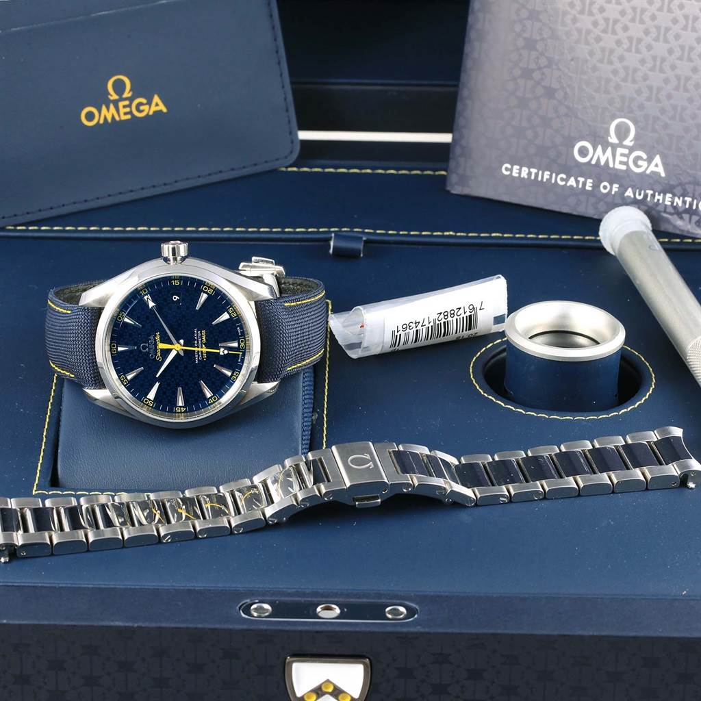 The image shows a close-up view of the Omega Aqua Terra 231.10.42.21.03.004 Men's Stainless Steel Blue Dial 231.10.42.21.03.004 Men's Stainless Steel Blue Dial watch, its box, accessories, including an additional bracelet and certification documents.