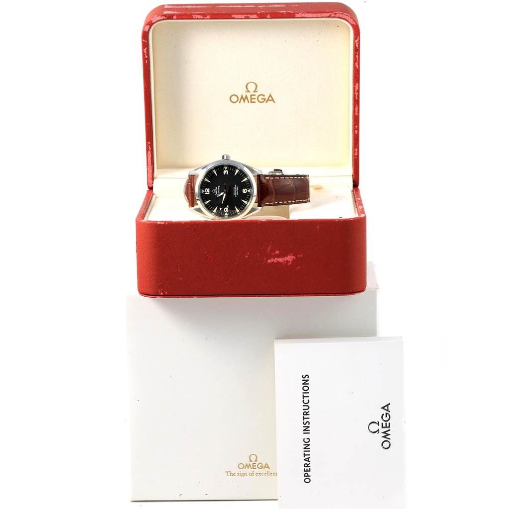 The image shows the Omega Aqua Terra 2803.52.37 Men's Stainless Steel Black Dial 2803.52.37 Men's Stainless Steel Black Dial watch with a brown leather strap, placed in an open red watch box with the operating instructions beside it.