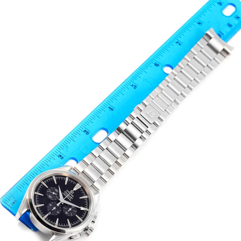 The image shows the Omega Aqua Terra 2512.50.00 Men's Stainless Steel Black Dial 2512.50.00 Men's Stainless Steel Black Dial watch laid flat with the face, bezel, and bracelet visible next to a blue ruler.