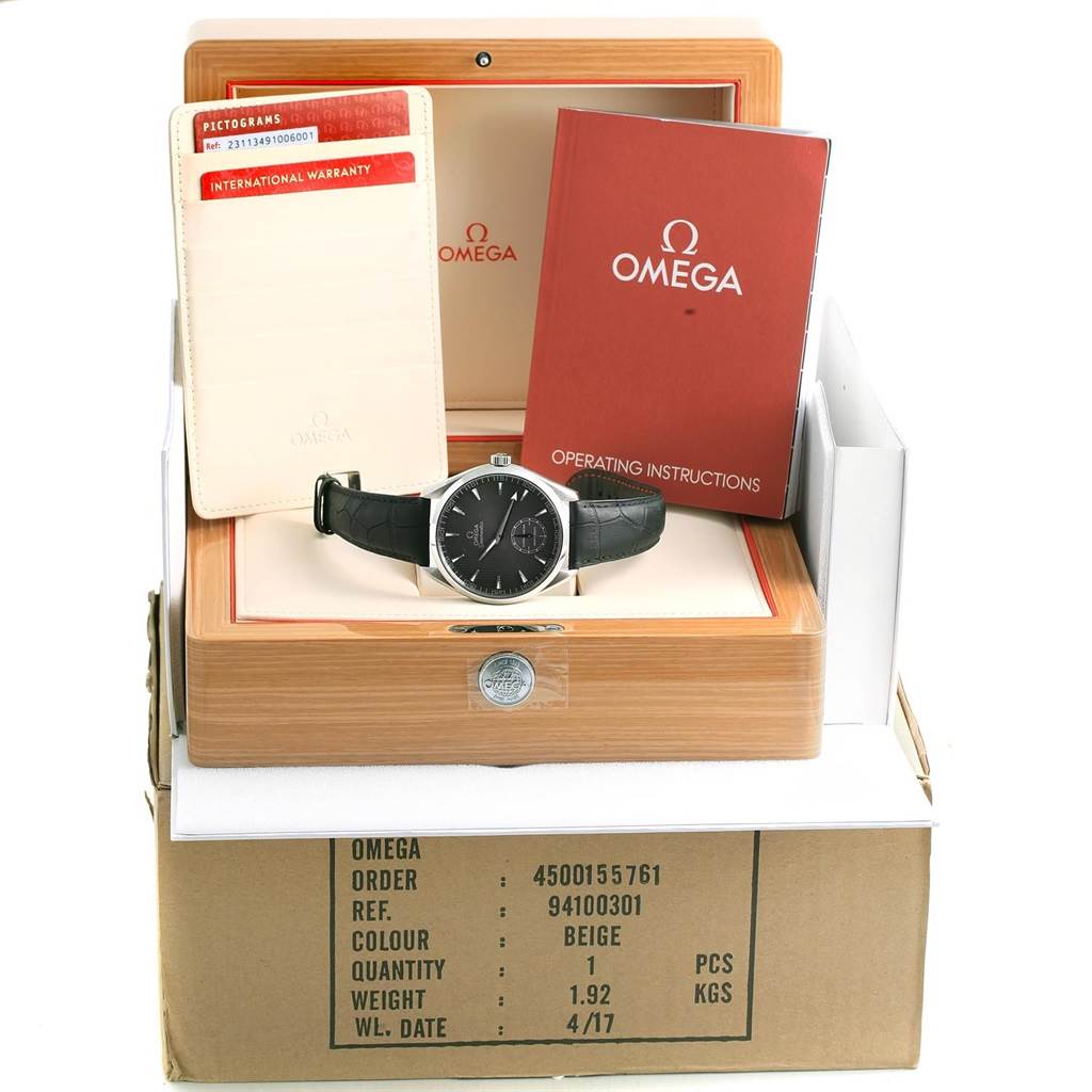 This image shows an Omega Aqua Terra 231.13.49.10.06.001 Men's Stainless Steel Grey Dial 231.13.49.10.06.001 Men's Stainless Steel Grey Dial watch with its warranty card and operating instructions, displayed in its original wooden box.