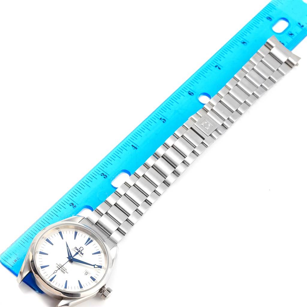 The image shows an Omega Aqua Terra 2502.33.00 Men's Stainless Steel White Dial 2502.33.00 Men's Stainless Steel White Dial watch placed next to a blue ruler, displaying its face, bracelet, and clasp.