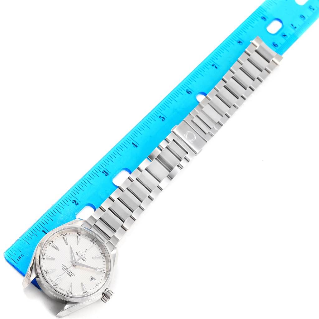 The image shows an Omega Aqua Terra 231.10.42.21.02.001 Men
s Stainless Steel Silver Dial 231.10.42.21.02.001 Men
s Stainless Steel Silver Dial watch laid flat next to a ruler, highlighting the face and metal bracelet.