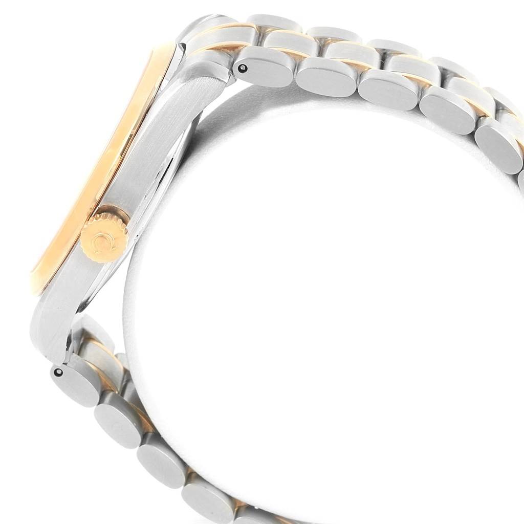 This side view of the Omega Aqua Terra 2317.30.00 Steel and Gold (two tone) Silver Dial 2317.30.00 Steel and Gold (two tone) Silver Dial watch displays its crown and part of the bracelet.