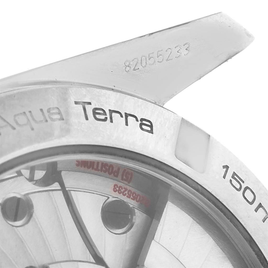 The image shows a close-up of the Omega Aqua Terra 231.10.39.21.02.001 Stainless Steel Silver Dial 231.10.39.21.02.001 Stainless Steel Silver Dial watch, highlighting the bezel and partial view of the dial and serial number.