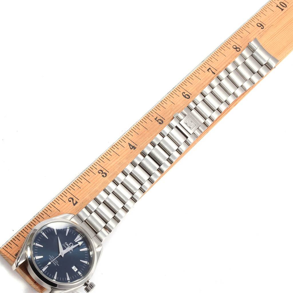 The image shows the Omega Aqua Terra 2503.80.00 Men's Stainless Steel Blue Dial 2503.80.00 Men's Stainless Steel Blue Dial watch from a top view, displaying its face, bracelet, and clasp alongside a ruler for scale.