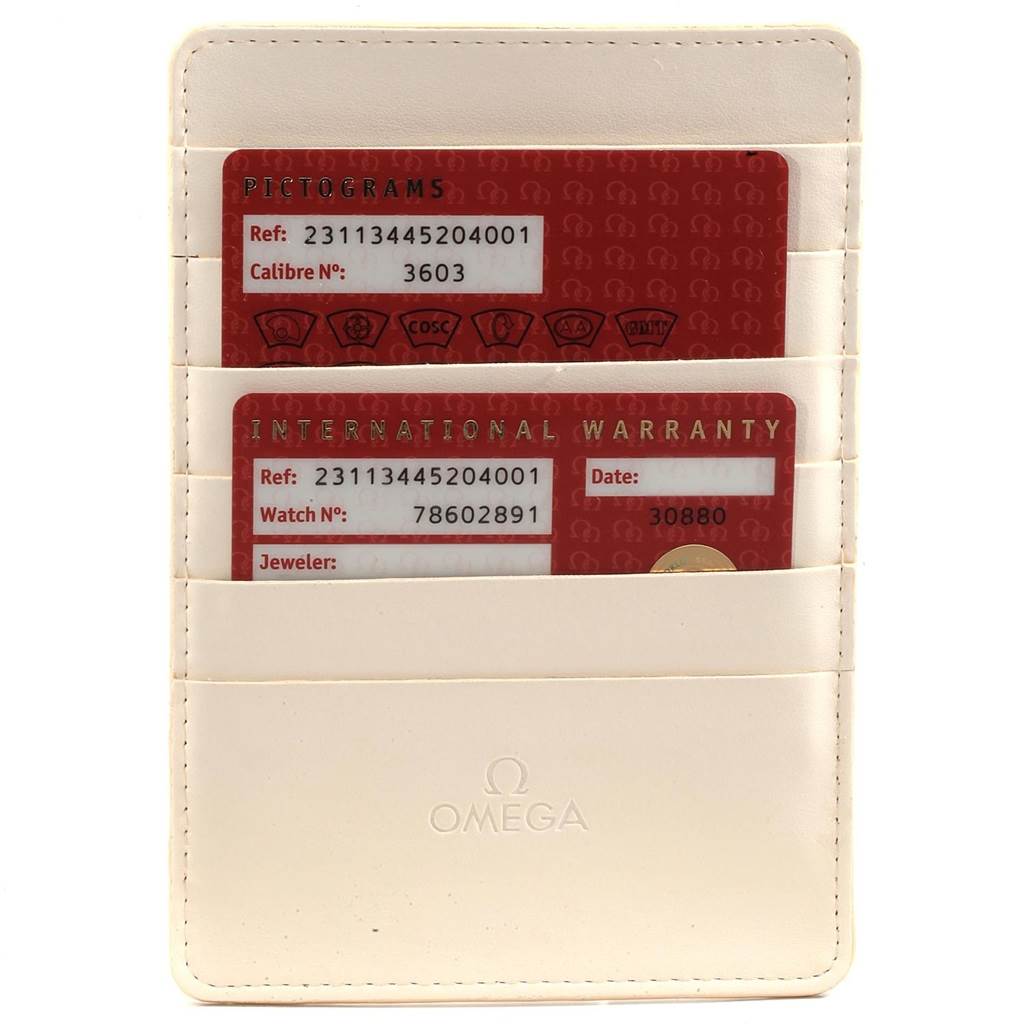 The image shows the international warranty and pictogram cards of the Omega Aqua Terra 231.13.44.52.04.001 Men's Stainless Steel White Dial 231.13.44.52.04.001 Men's Stainless Steel White Dial model in a cream cardholder.