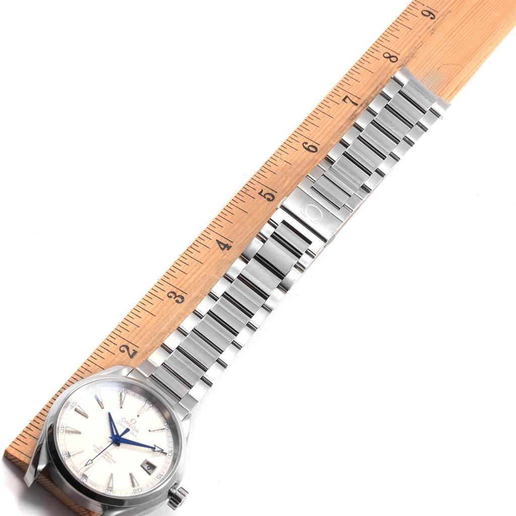 The Omega Aqua Terra 231.10.42.21.02.002 Men
s Stainless Steel Silver Dial 231.10.42.21.02.002 Men
s Stainless Steel Silver Dial watch is shown from a top-down angle, displaying the face, bezel, and metal bracelet next to a ruler.