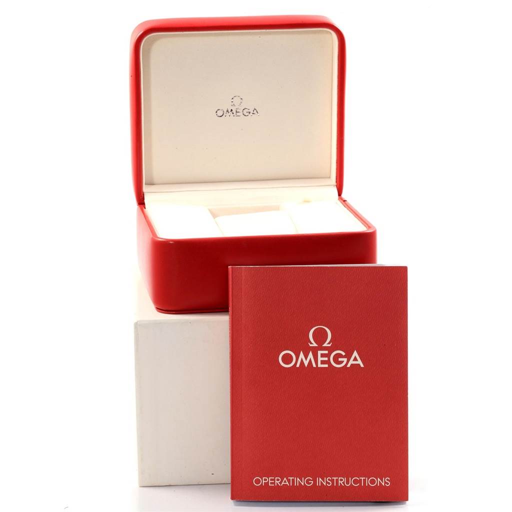 The image shows the Omega Aqua Terra 2317.30.00 Men's Steel and Gold (two tone) Silver Dial 2317.30.00 Men's Steel and Gold (two tone) Silver Dial's red watch box and a red operating instructions manual.