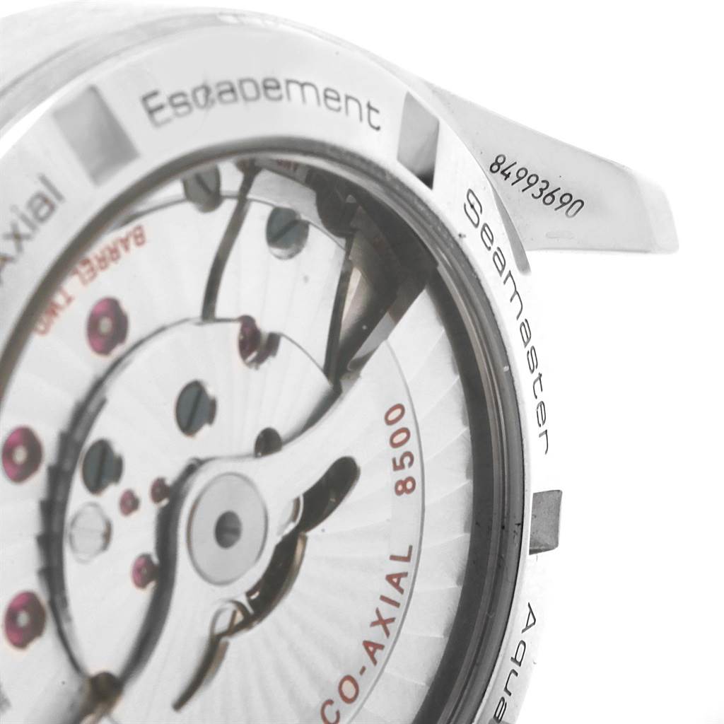 The image shows a close-up of the Omega Aqua Terra 231.10.39.21.54.001 Men's Stainless Steel White Dial 231.10.39.21.54.001 Men's Stainless Steel White Dial watch's movement, including the 8500 Co-Axial escapement and parts of the case back.