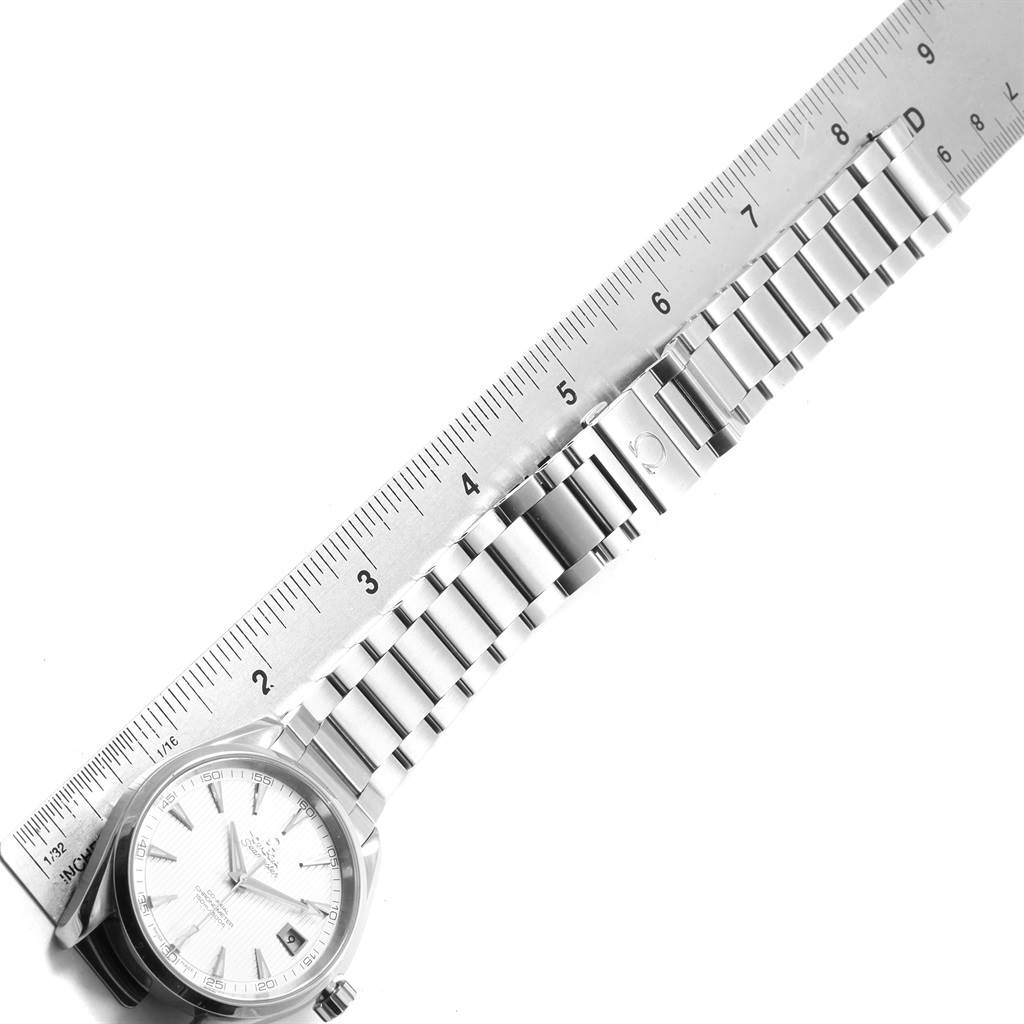 The image shows an Omega Aqua Terra 231.10.42.21.02.001 Men
s Stainless Steel Silver Dial 231.10.42.21.02.001 Men
s Stainless Steel Silver Dial watch and part of its metal bracelet next to a ruler, photographed from above.