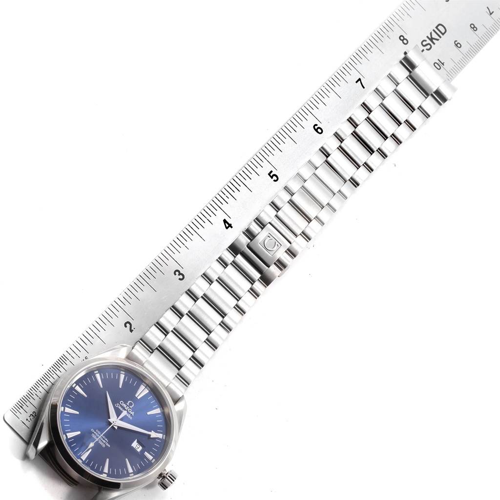 The image shows an Omega Aqua Terra 2502.80.00 Men's Stainless Steel Blue Dial 2502.80.00 Men's Stainless Steel Blue Dial watch lying flat, with its face and metal bracelet measured against a ruler.