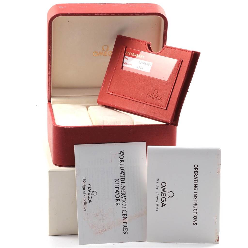 This image shows an Omega Aqua Terra 2502.80.00 Men's Stainless Steel Blue Dial 2502.80.00 Men's Stainless Steel Blue Dial watch case, red cardholder, and instruction manuals.