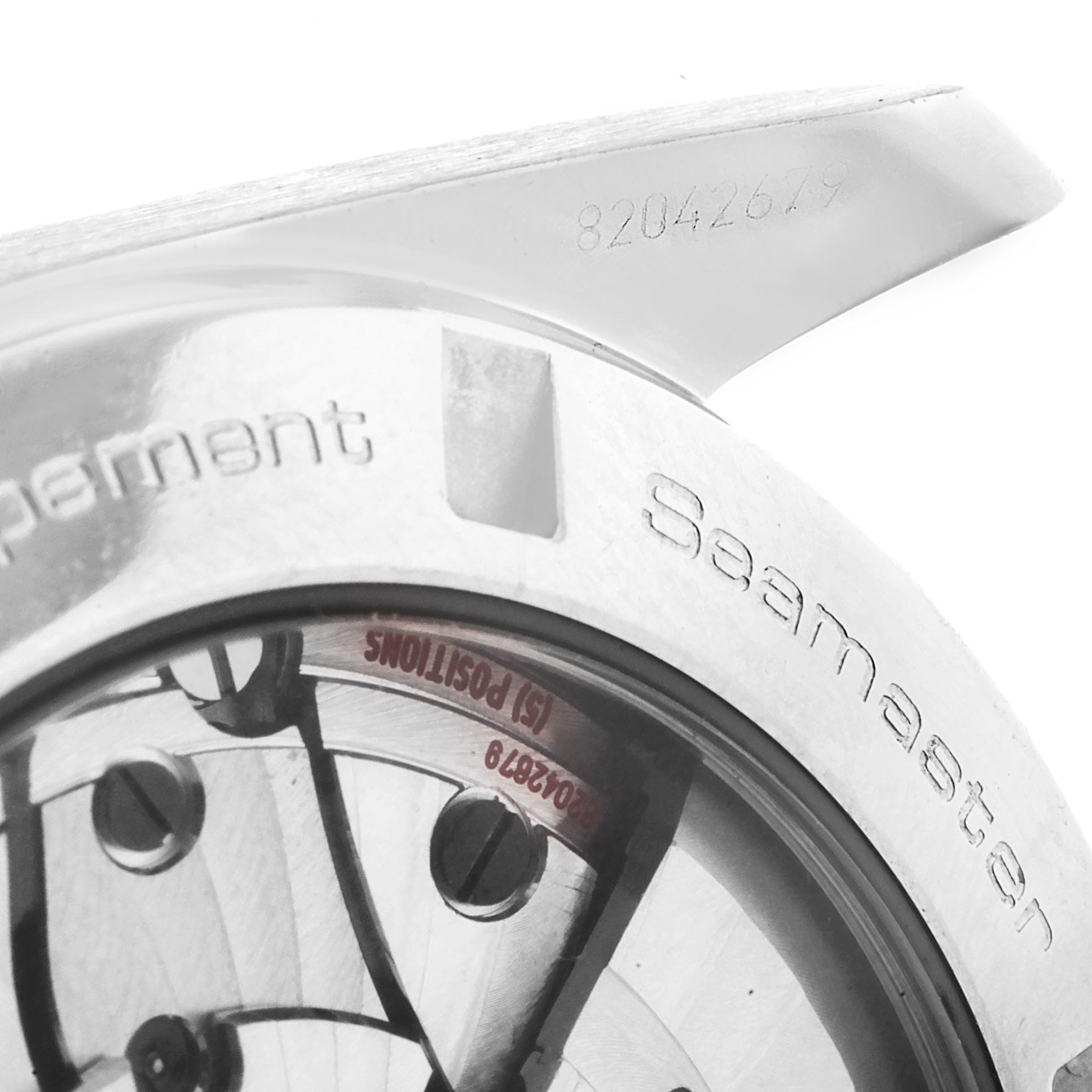 The image shows a close-up of the back case of an Omega Aqua Terra 231.10.42.21.06.001 Men's Stainless Steel Grey Dial 231.10.42.21.06.001 Men's Stainless Steel Grey Dial Seamaster watch, highlighting the serial number and internal movement details.