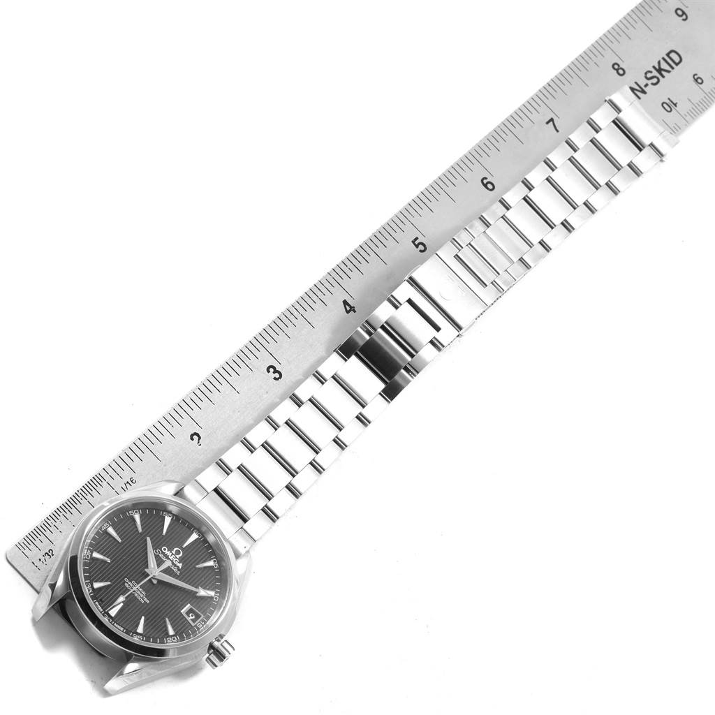 The image shows an Omega Aqua Terra 231.10.39.60.02.001 Men's Stainless Steel Grey Dial 231.10.39.60.02.001 Men's Stainless Steel Grey Dial watch with a stainless steel bracelet alongside a metal ruler.