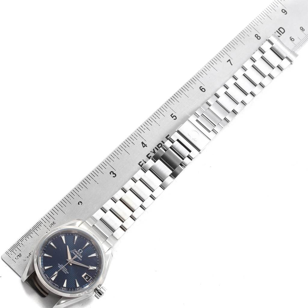 The Omega Aqua Terra 231.10.39.21.03.001 Men
s Stainless Steel Blue Dial 231.10.39.21.03.001 Men
s Stainless Steel Blue Dial watch is shown horizontally with the face, crown, and stainless steel bracelet visible alongside a ruler.