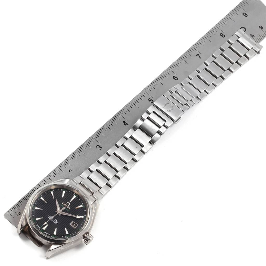 The image shows a top-down view of an Omega Aqua Terra 231.10.42.21.01.001 Men
s Stainless Steel Black Dial 231.10.42.21.01.001 Men
s Stainless Steel Black Dial watch with a metal bracelet next to a ruler.