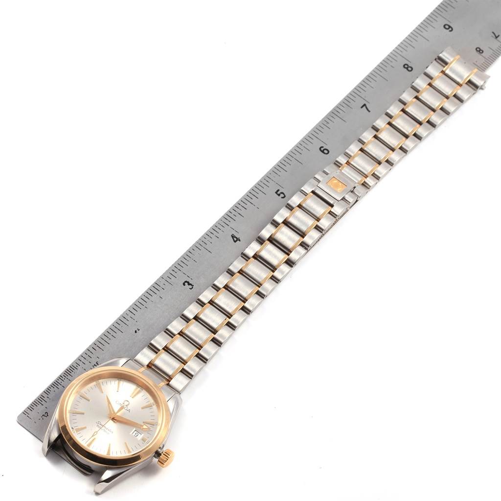 The image shows an Omega Aqua Terra 2318.30.00 Men
s Steel and Gold (two tone) Silver Dial 2318.30.00 Men
s Steel and Gold (two tone) Silver Dial watch laid flat with its bracelet measured by a ruler.
