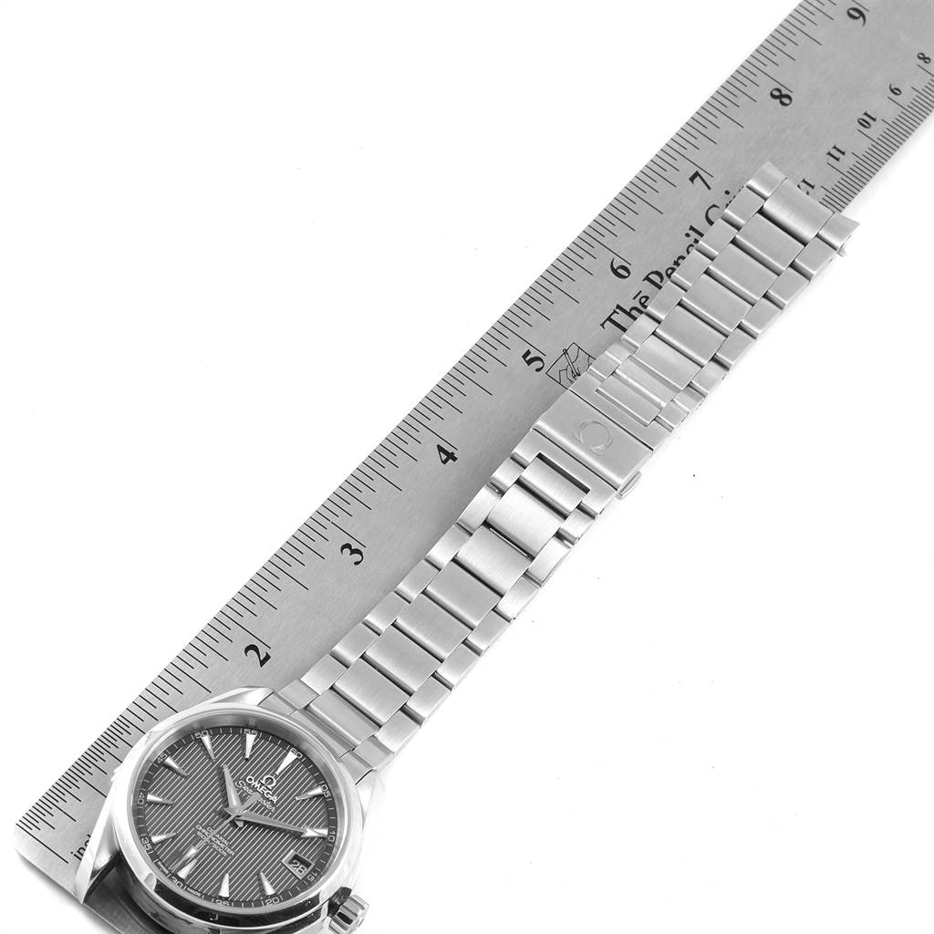The image shows an Omega Aqua Terra 231.10.39.21.06.001 Men's Stainless Steel Grey Dial 231.10.39.21.06.001 Men's Stainless Steel Grey Dial watch, highlighting the face, bracelet, and buckle, alongside a ruler for scale.