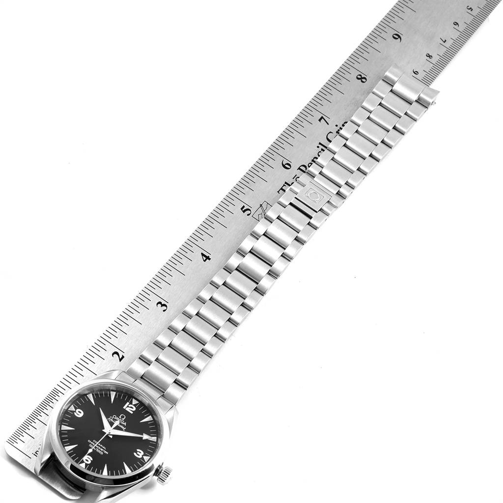 The image shows an Omega Aqua Terra 2503.52.00 Men
s Stainless Steel Black Dial 2503.52.00 Men
s Stainless Steel Black Dial watch from a top-down angle, highlighting the face and metallic bracelet alongside a ruler.