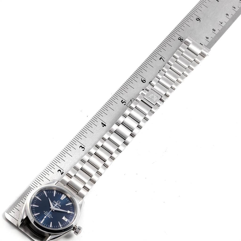 The image shows an Omega Aqua Terra 2504.80.00 Men
s Stainless Steel Blue Dial 2504.80.00 Men
s Stainless Steel Blue Dial watch laying flat, with the face and metal bracelet alongside a measuring ruler.