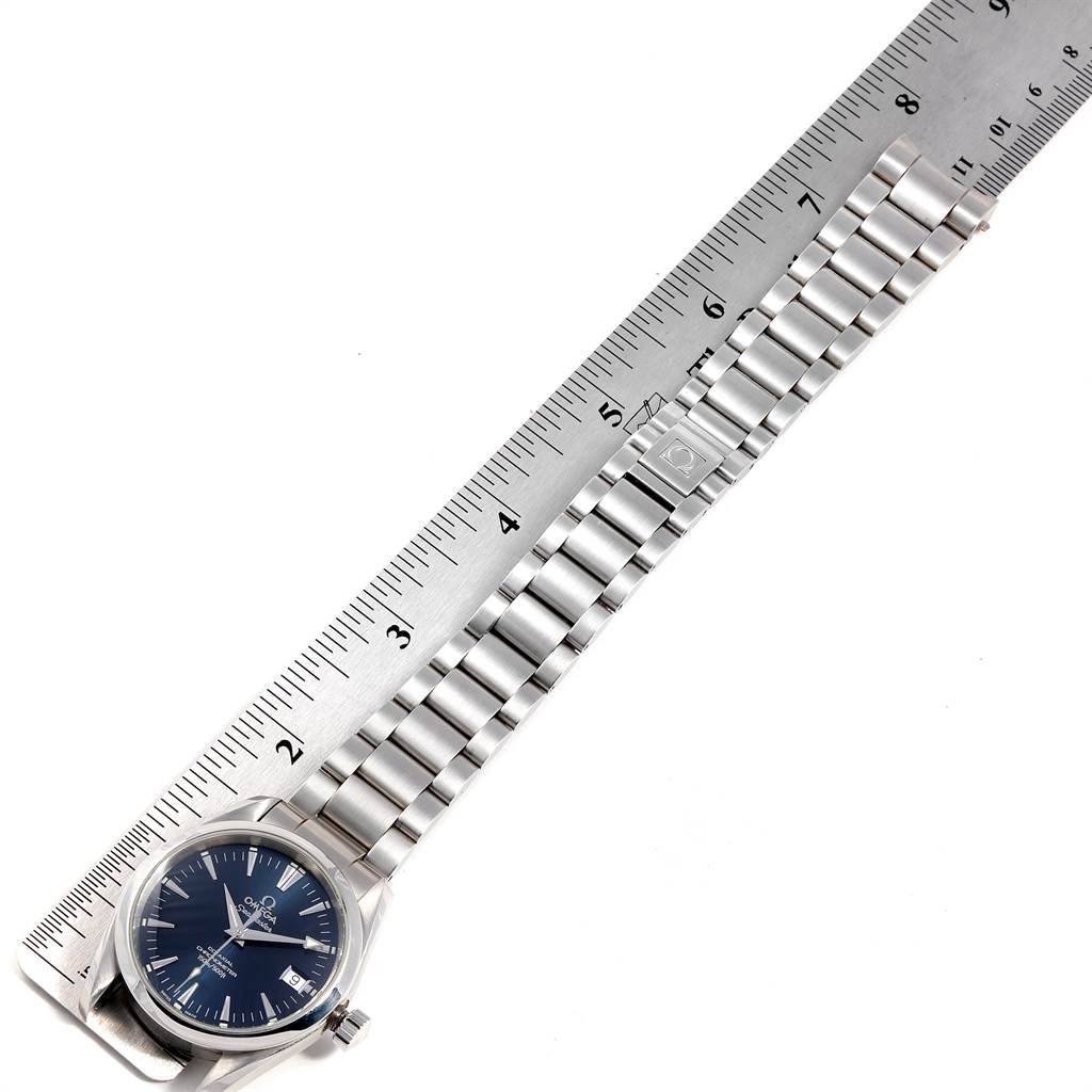 The Omega Aqua Terra 2504.80.00 Men
s Stainless Steel Blue Dial 2504.80.00 Men
s Stainless Steel Blue Dial watch is shown from a top-down angle with its stainless steel bracelet next to a ruler.