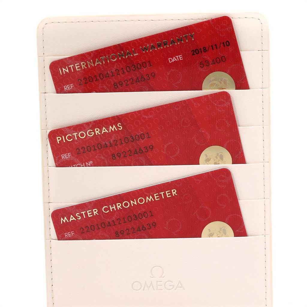 The image shows three cards—International Warranty, Pictograms, and Master Chronometer—stored in a white Omega cardholder for the Aqua Terra model.