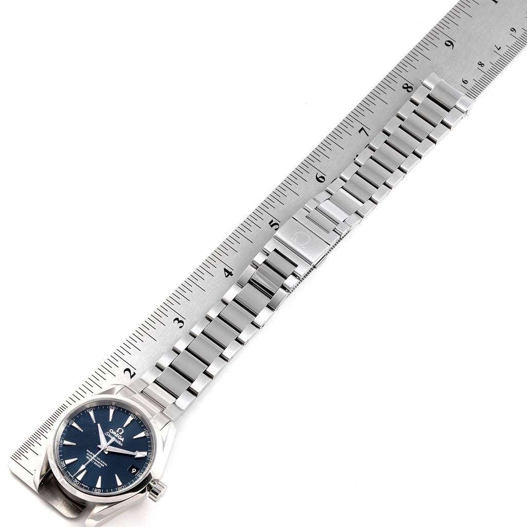 The image shows an Omega Aqua Terra 231.10.39.21.03.002 Men
s Stainless Steel Blue Dial 231.10.39.21.03.002 Men
s Stainless Steel Blue Dial watch and its metal bracelet alongside a ruler, photographed from an overhead angle.