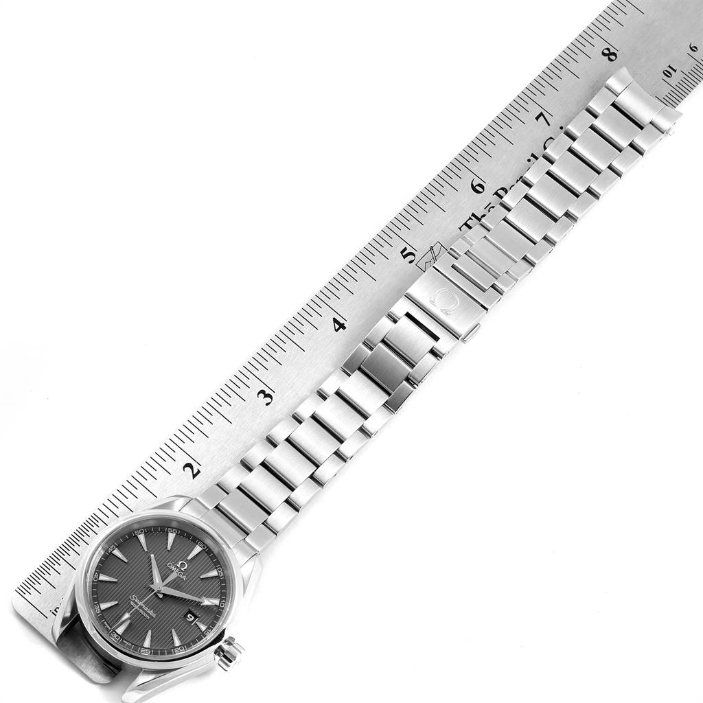 The image shows the top view of an Omega Aqua Terra 231.10.39.61.06.001 Men's Stainless Steel Grey Dial 231.10.39.61.06.001 Men's Stainless Steel Grey Dial watch, highlighting its face, stainless steel bracelet, and part of a ruler for scale.