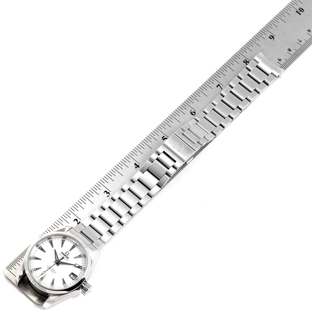 The Omega Aqua Terra 231.10.39.21.54.001 Men's Stainless Steel White Dial 231.10.39.21.54.001 Men's Stainless Steel White Dial watch is shown laid flat, measured next to a ruler, displaying its face and metal bracelet.