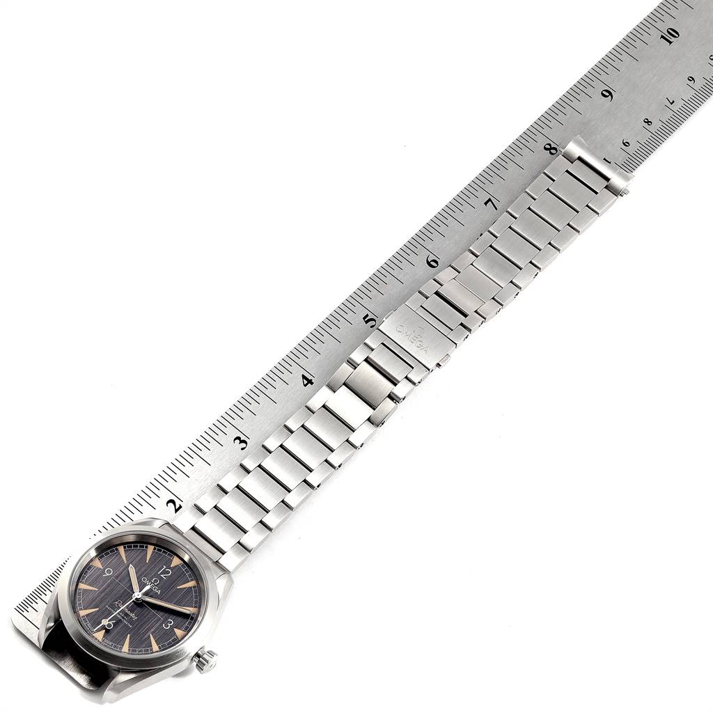 The image shows an Omega Aqua Terra 220.10.40.20.01.001 Men's Stainless Steel Black Dial 220.10.40.20.01.001 Men's Stainless Steel Black Dial watch laid flat with a ruler measuring its length, displaying the face, bezel, crown, and stainless steel bracelet.