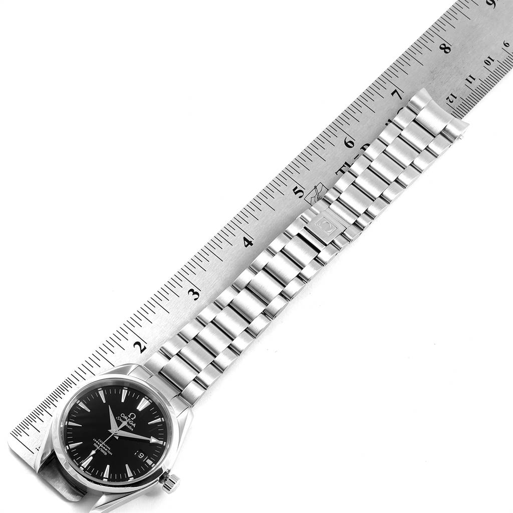 The image shows an Omega Aqua Terra 2503.50.00 Men
s Stainless Steel Black Dial 2503.50.00 Men
s Stainless Steel Black Dial watch laid flat, with its stainless steel band and dial face measured against a ruler.