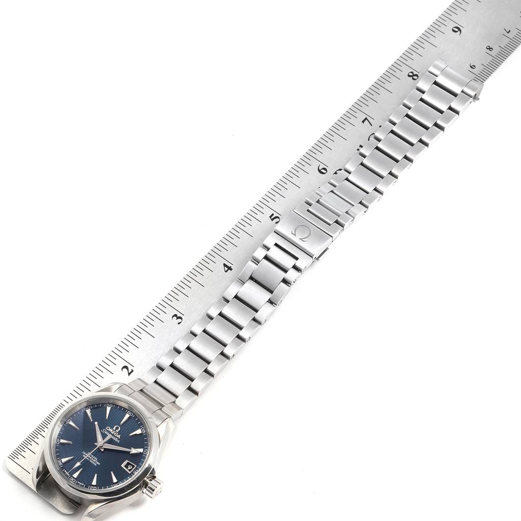 The image shows an Omega Aqua Terra 231.10.39.21.03.001 Men's Stainless Steel Blue Dial 231.10.39.21.03.001 Men's Stainless Steel Blue Dial watch laid next to a ruler, displaying its dial and metal bracelet.