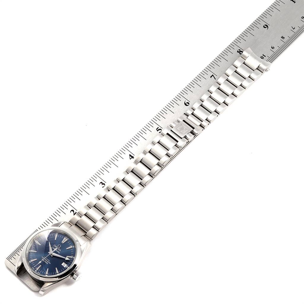 The Omega Aqua Terra 2504.80.00 Men
s Stainless Steel Blue Dial 2504.80.00 Men
s Stainless Steel Blue Dial watch is shown in a top-down view, highlighting the face, crown, and full metal bracelet against a ruler for scale.