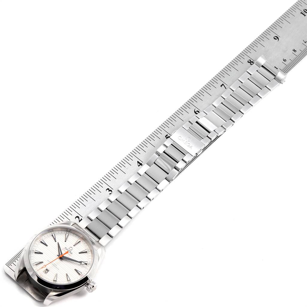 The image shows an Omega Aqua Terra 220.10.41.21.02.001 Men's Stainless Steel Silver Dial 220.10.41.21.02.001 Men's Stainless Steel Silver Dial watch laid flat beside a ruler, highlighting its stainless steel bracelet and face.