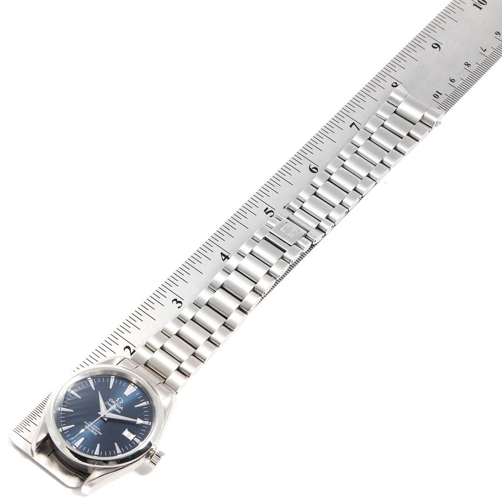 The Omega Aqua Terra 2503.80.00 Men
s Stainless Steel Blue Dial 2503.80.00 Men
s Stainless Steel Blue Dial watch is shown flat, highlighting its face, stainless steel bracelet, and positioned alongside a ruler.