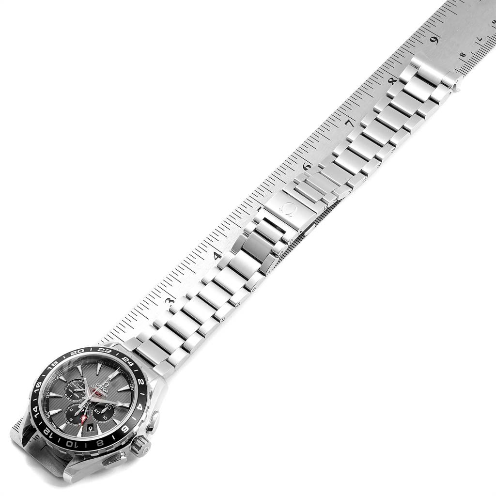 The image shows the Omega Aqua Terra 231.10.44.52.06.001 Men's Stainless Steel Grey Dial 231.10.44.52.06.001 Men's Stainless Steel Grey Dial watch laid flat, showcasing its face and metal bracelet against a ruler.