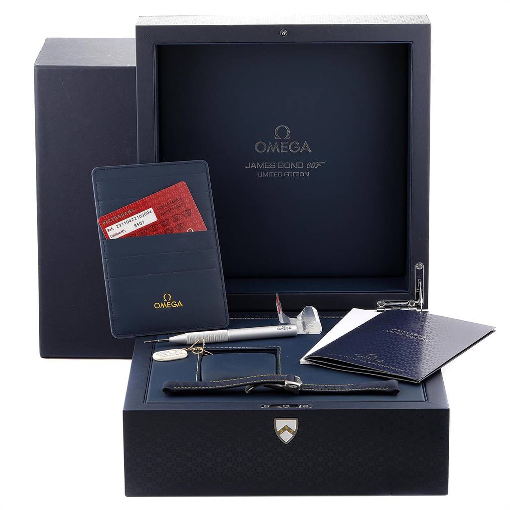 The image shows an Omega Aqua Terra 231.10.42.21.03.004 Men's Stainless Steel Blue Dial 231.10.42.21.03.004 Men's Stainless Steel Blue Dial James Bond Limited Edition box with accessories including straps, a pen, warranty card, and booklets.