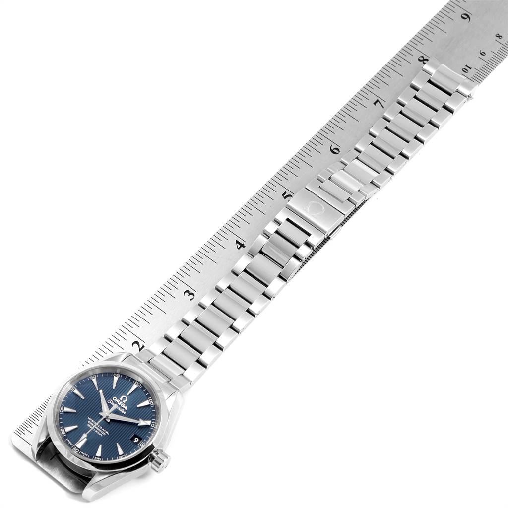 The Omega Aqua Terra 231.10.39.21.03.002 Men
s Stainless Steel Blue Dial 231.10.39.21.03.002 Men
s Stainless Steel Blue Dial watch is shown from a top-down angle, featuring its blue dial and stainless steel bracelet aligned next to a ruler.