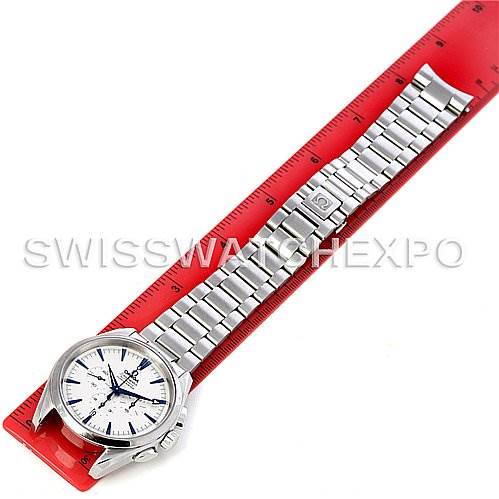 The image displays an Omega Aqua Terra 2512.30 Men
s Stainless Steel Silver Dial 2512.30 Men
s Stainless Steel Silver Dial watch laid flat on a red ruler, showcasing the full length of the watch and its metal bracelet.