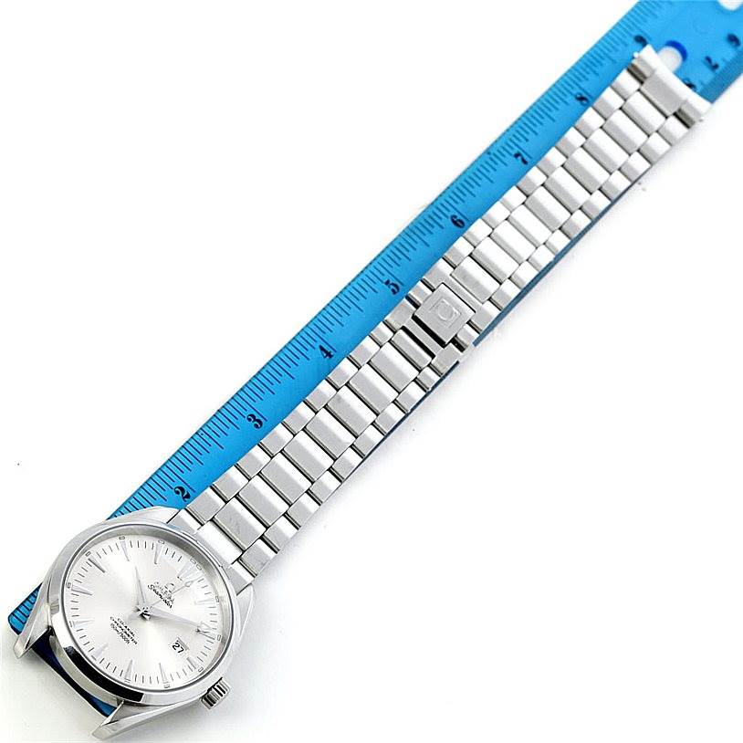 The Omega Aqua Terra 2502.30.00 Men's Stainless Steel Silver Dial 2502.30.00 Men's Stainless Steel Silver Dial watch is shown from a top-down angle, with its full bracelet alongside a blue ruler for scale.