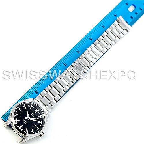 The image shows an Omega Aqua Terra 2517.50.00 Men's Stainless Steel Black Dial 2517.50.00 Men's Stainless Steel Black Dial watch placed next to a blue ruler, highlighting the bracelet and watch face from an overhead angle.